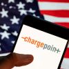The ChargePoint EV app on a smartphone with an American flag background
