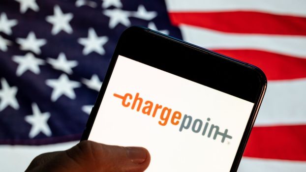 The ChargePoint EV app on a smartphone with an American flag background