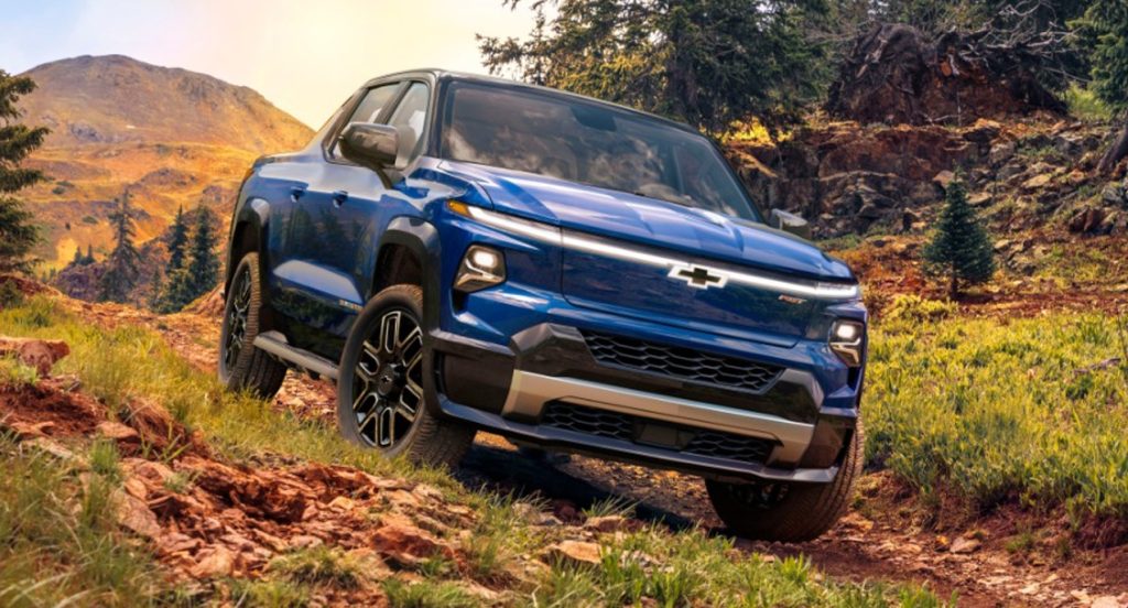 A blue 2024 Chevy Silverado EV electric pickup truck is off-roading.