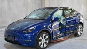 Blue Tesla Model 3 after crash test impact on driver's side