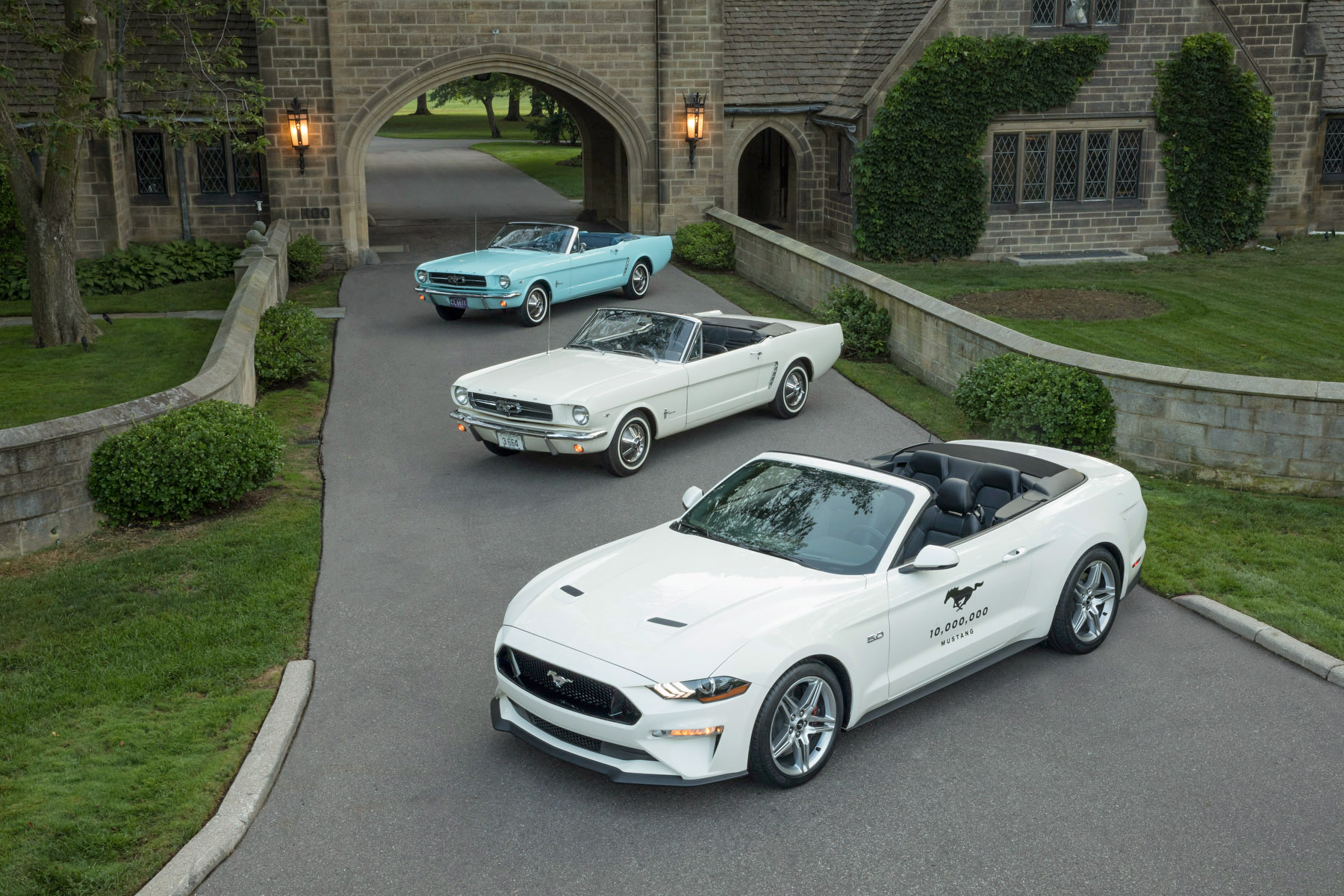The first Mustang bought, the ceremonial VIN 1 first Mustang, and the 10-millionth Mustang on the grounds of the Edsel  Eleanor Ford House.