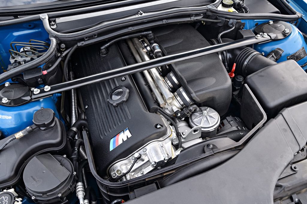 The S54 inline-six engine in a blue E46 BMW M3 Convertible's engine bay