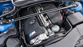 The S54 inline-six engine in a blue E46 BMW M3 Convertible's engine bay