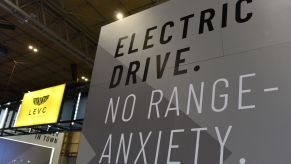 An EV sign promoting electric driving range seen during the Commercial Vehicle Show in Birmingham, England