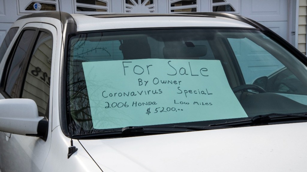 For sale sign in window of Honda Civic, highlighting tips for preparing to sell car to make the most money