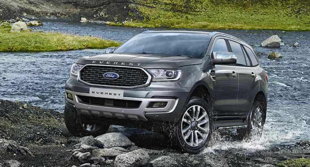 A gray Ford Everest midsize SUV is driving off-road.
