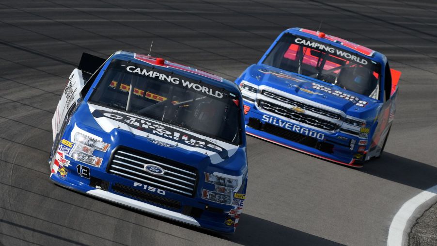 Ford F-150 and Chevy Silverado NASCAR trucks racing during Camping World Truck Series in Madison, Illinois
