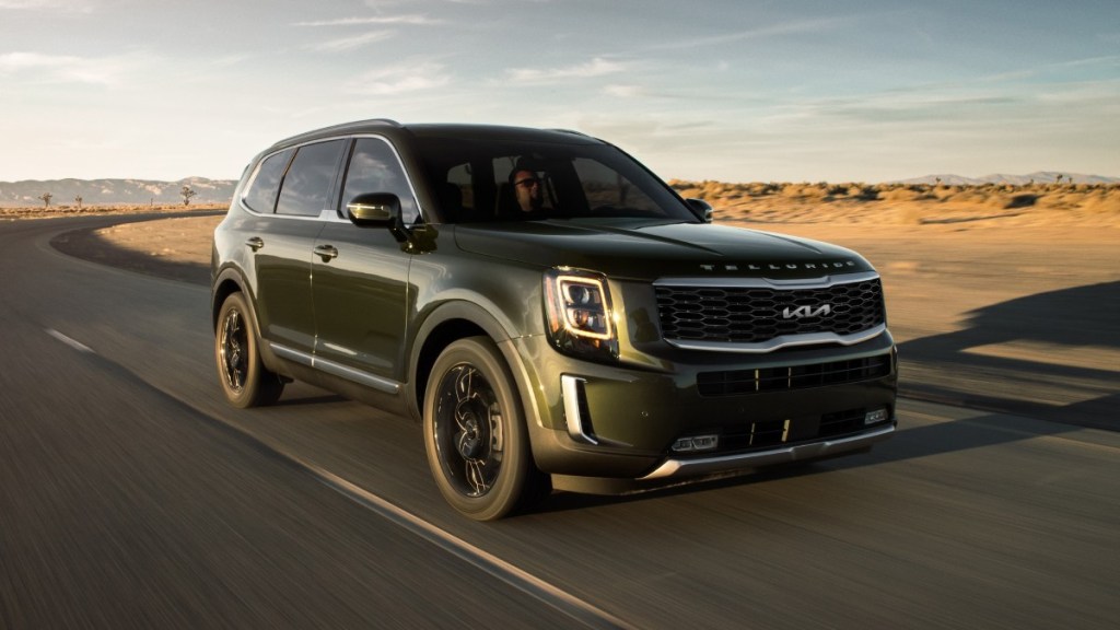 Front angle view of Dark Moss 2022 Kia Telluride - features, passenger space, cargo space, and more make this three row SUV interior much better.