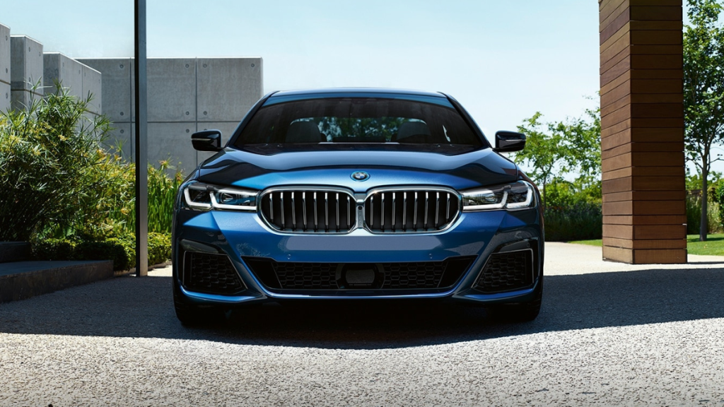 Front view of blue BMW 5 Series, the best car to buy used instead of new in 2022 due to high depreciation