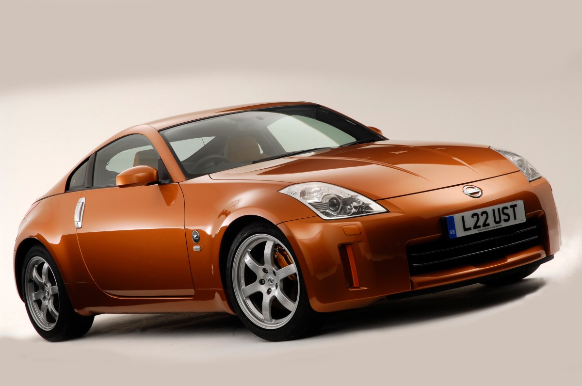 A 3/4 front view of an orange/gold 2006 Nissan 350Z parked with a white studio background.