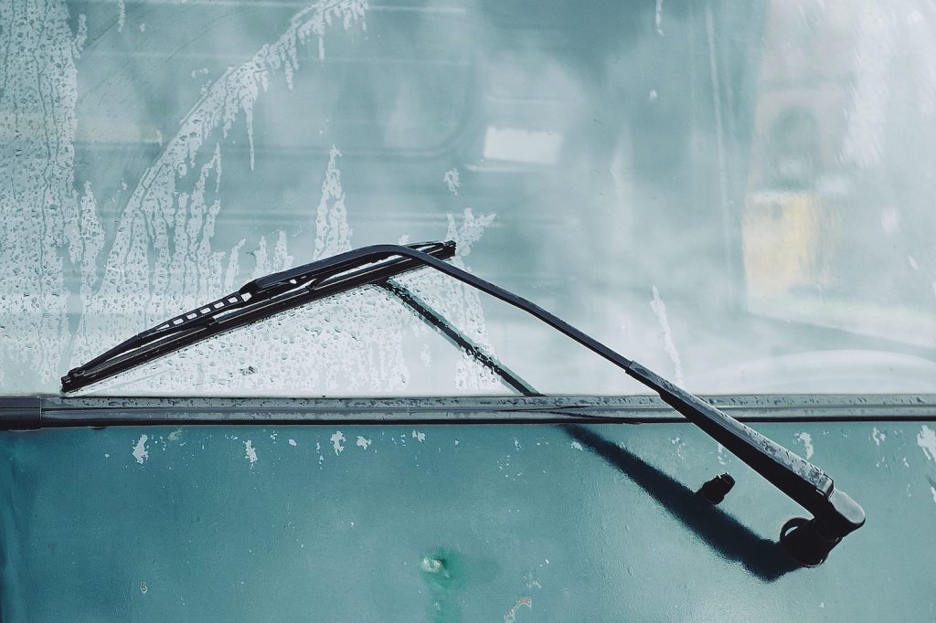 Closeup of the rear window wiper of a wet car.