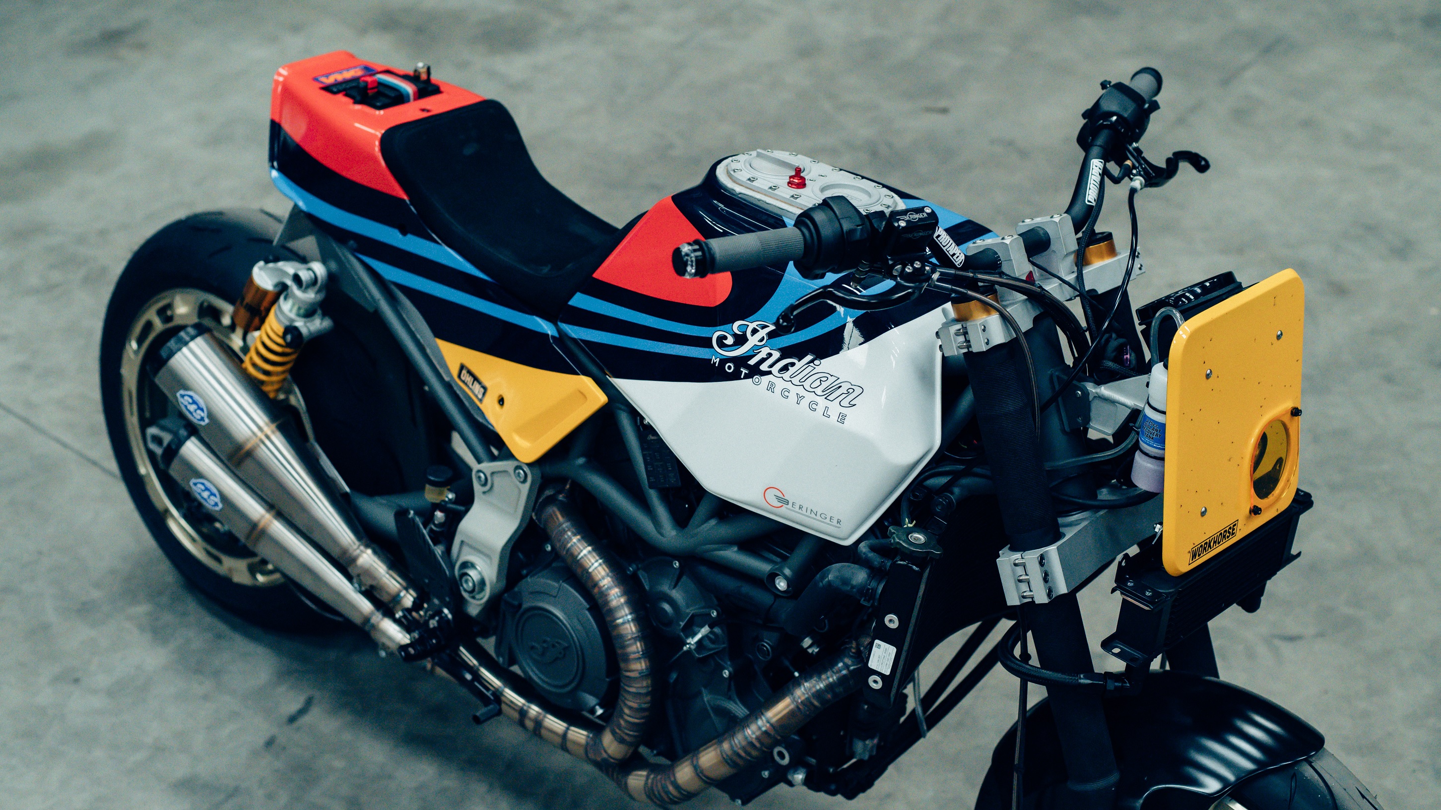 An overhead view of Workhorse Speed Shop's Martini-liveried Indian FTR AMA with yellow headlight surround