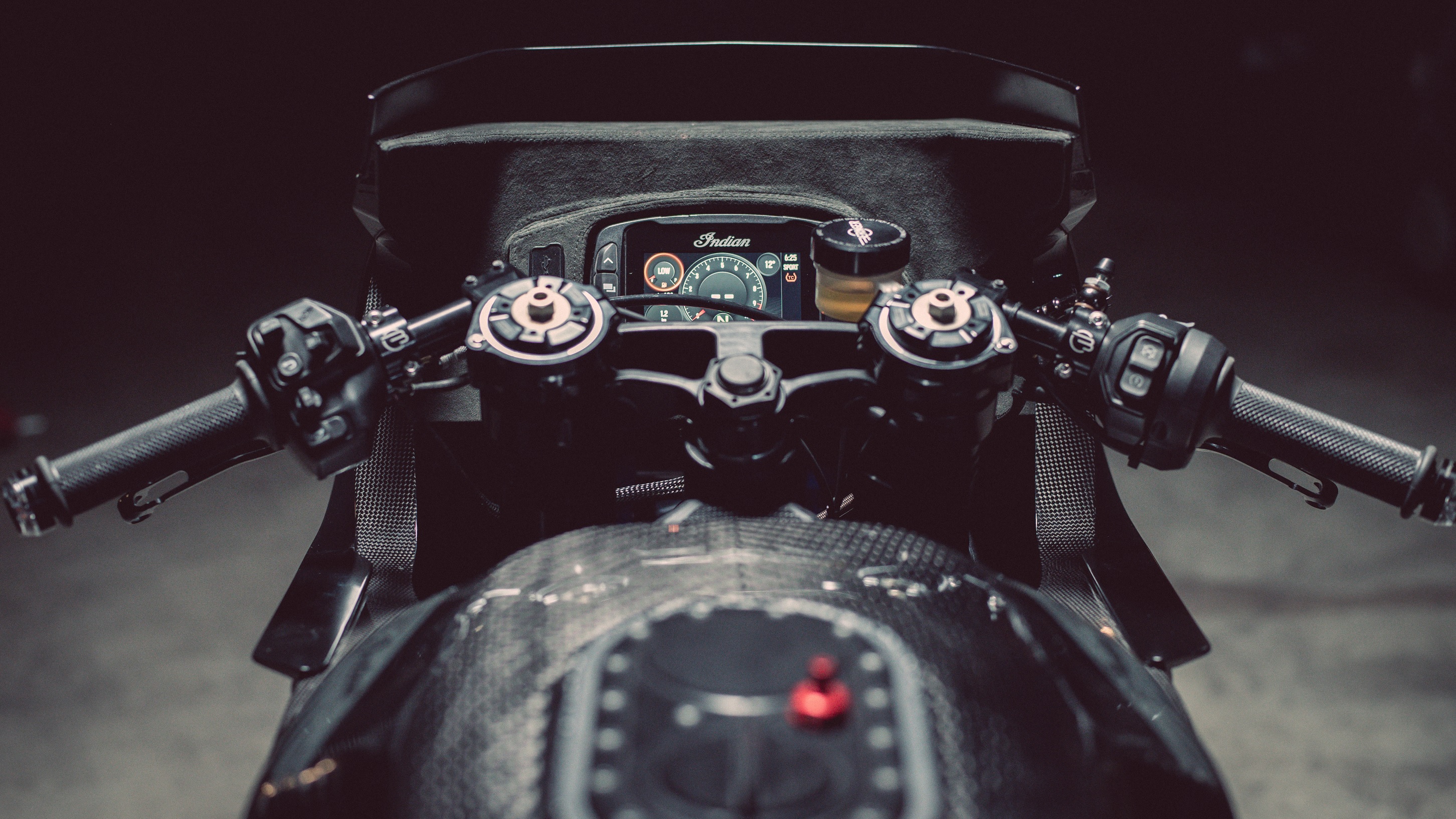 The black Alcantara dash, carbon-fiber dash, and handlebars on Workhorse Speed Shop's Indian FTR 'Black Swan'