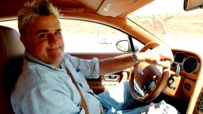 Closeup of Jay Leno smiling while driving a 2004 Bentley S2 Coupe