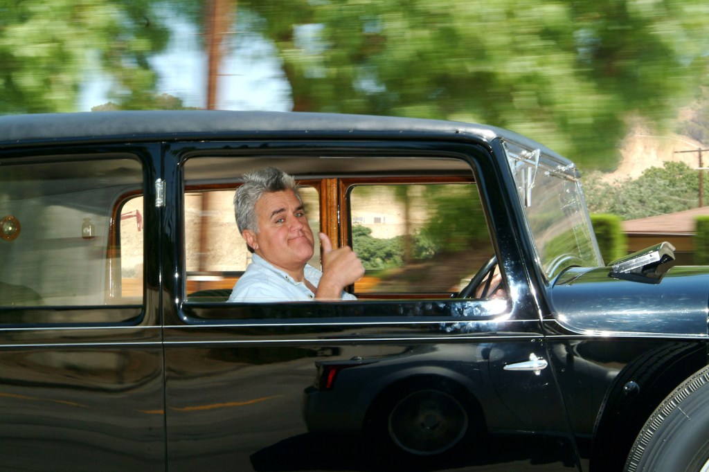 Jay Leno gives the thumbs-up while in a 1931 Bentley.
