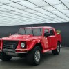 The ultra rare red Lamborghini LM002 pickup truck at a press event.