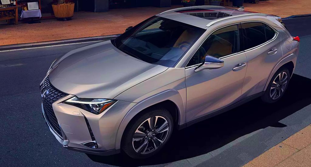 A gray 2022 Lexus UX 250h is driving on the road.