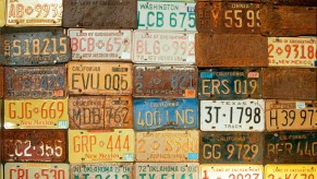 A wall covered in old license tags