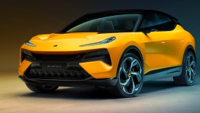 A yellow Lotus Eletre super SUV is parked.