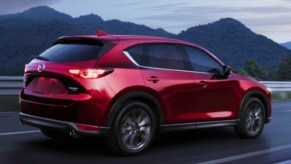 A red 2022 Mazda CX-5 small SUV is driving on the road.