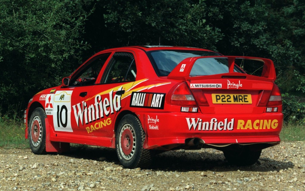 The rear 3/4 view of the red liveried Winfield Mitsubishi Lancer Evo IV rally car