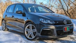A gray modified 2013 Volkswagen Golf R parked on the snow