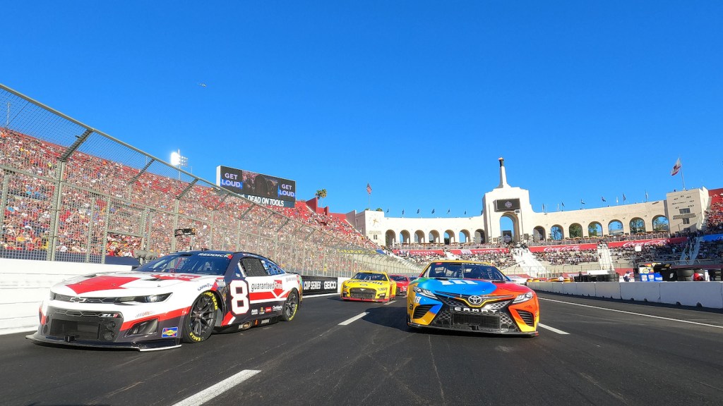 NASCAR Next Gen cars racing around the Los Angeles Coliseum.