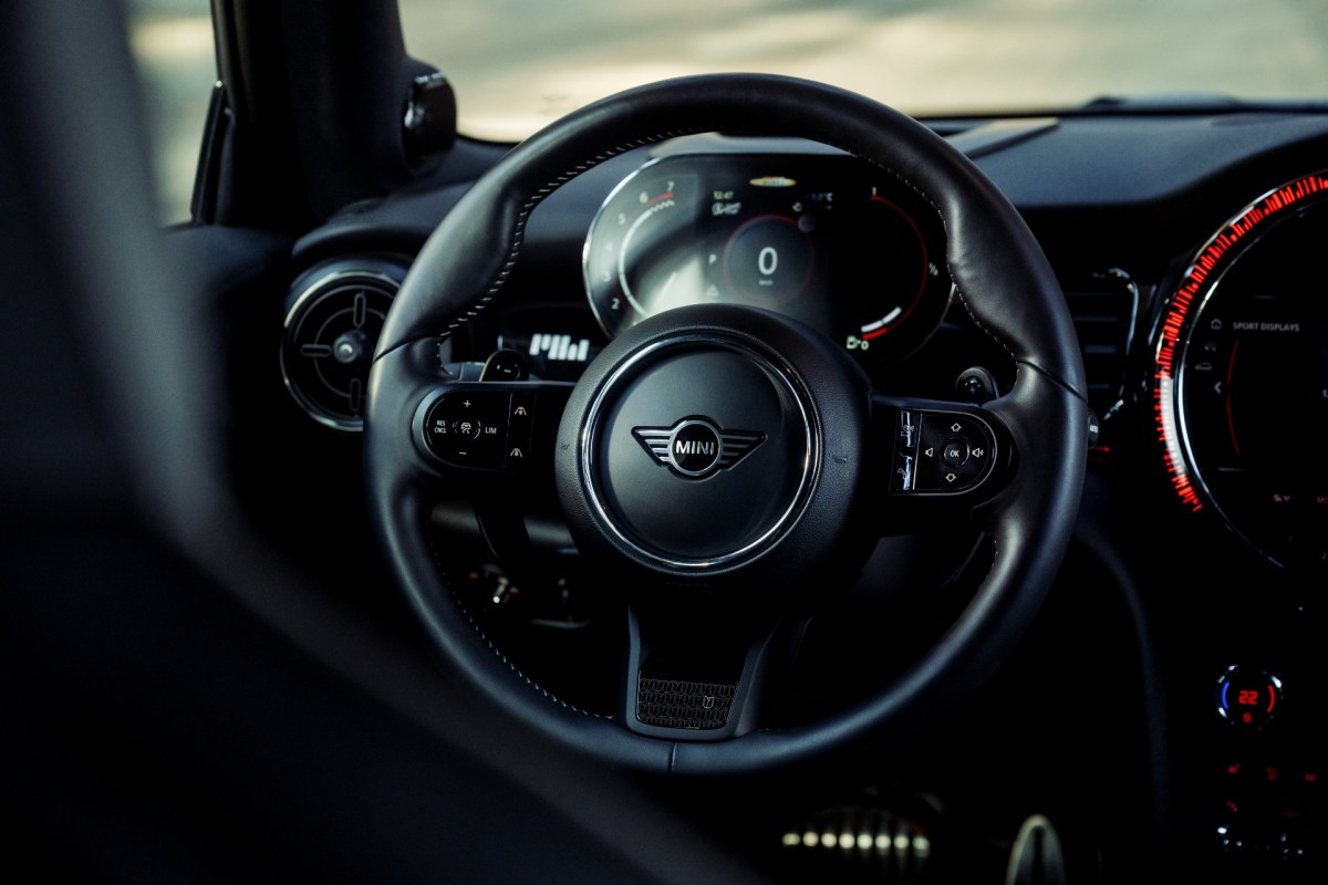 An image of the steering wheel and dashboard of a 2023 MINI Pat Moss Edition Cooper JCW. 