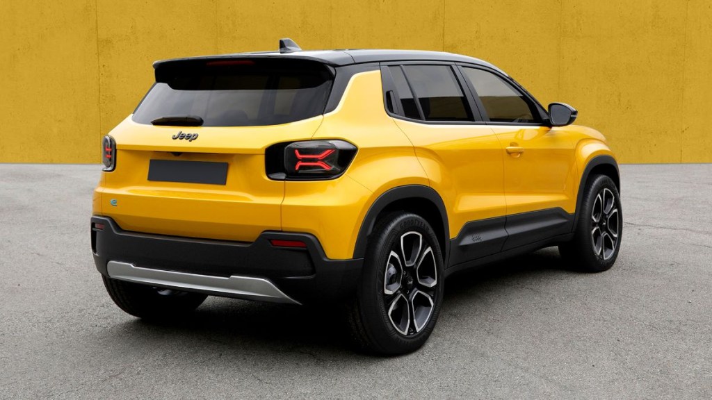 Passenger's side rear angle view of yellow and black 2024 Jeep EV, highlighting its release date and price
