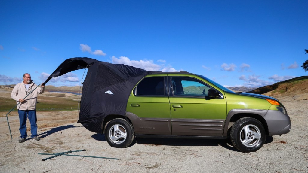 Green Pontiac Aztek with Tent Attached