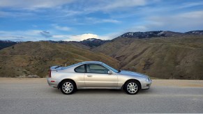 Silver 1996 Honda Prelude Si parked on mountain road with valley in background, passenger side