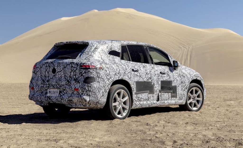 Rear view of camouflage-wrapped 2023 Mercedes-Benz EQS SUV, highlighting its release date and price
