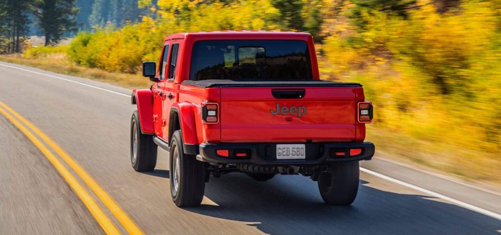 Rear view of red 2022 Jeep Gladiator, the midsize pickup truck with the best gas mileage in 2022