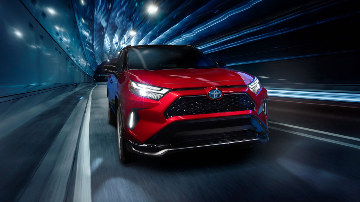 Red 2022 Toyota RAV4 Prime driving through a tunnel