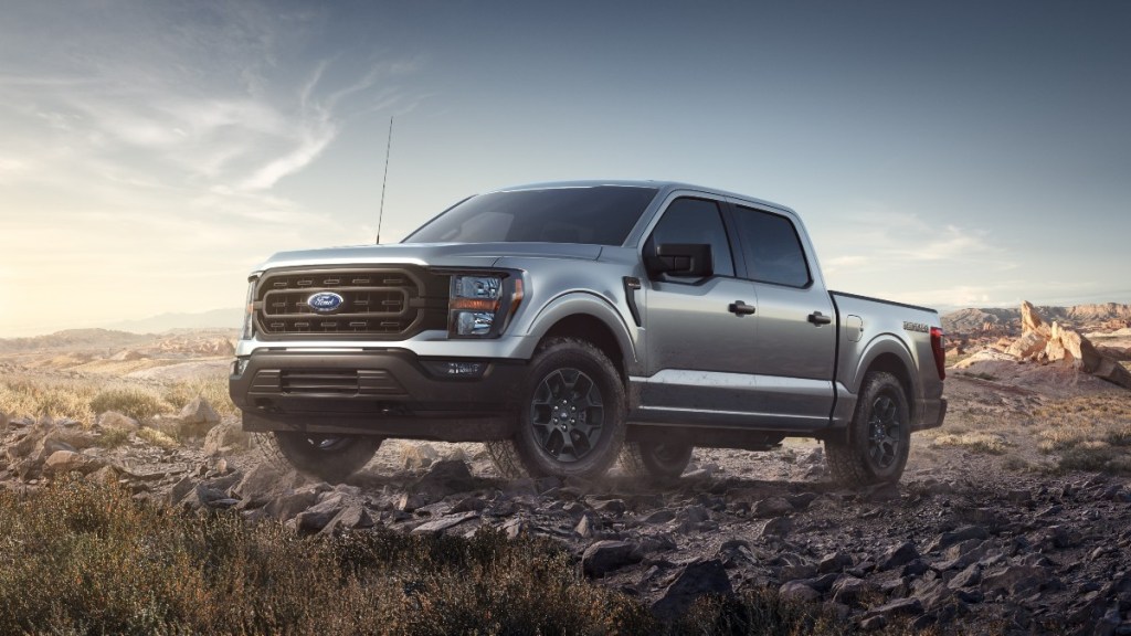 Silver 2023 Ford F-150 Rattler parked on rocky terrain, highlighting its release date, price, and features