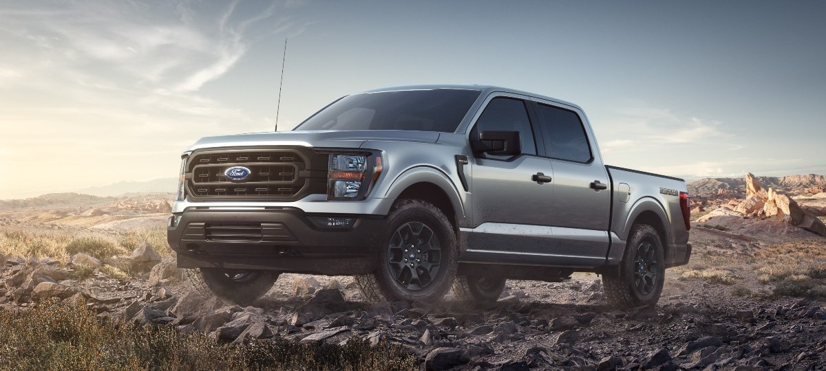 Silver 2023 Ford F-150 Rattler parked on rocky terrain, highlighting its release date, price, and features