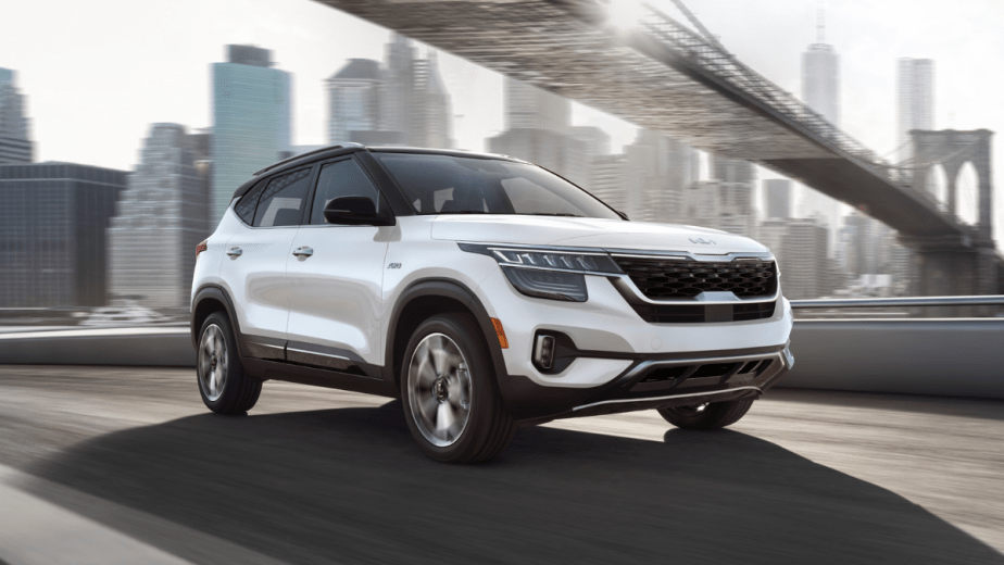 Snow White Pearl 2022 Kia Seltos driving under a bridge