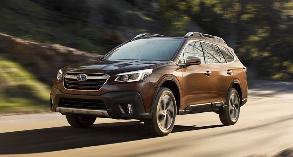 A brown 2022 Subaru Outback midsize SUV is driving on the road. 