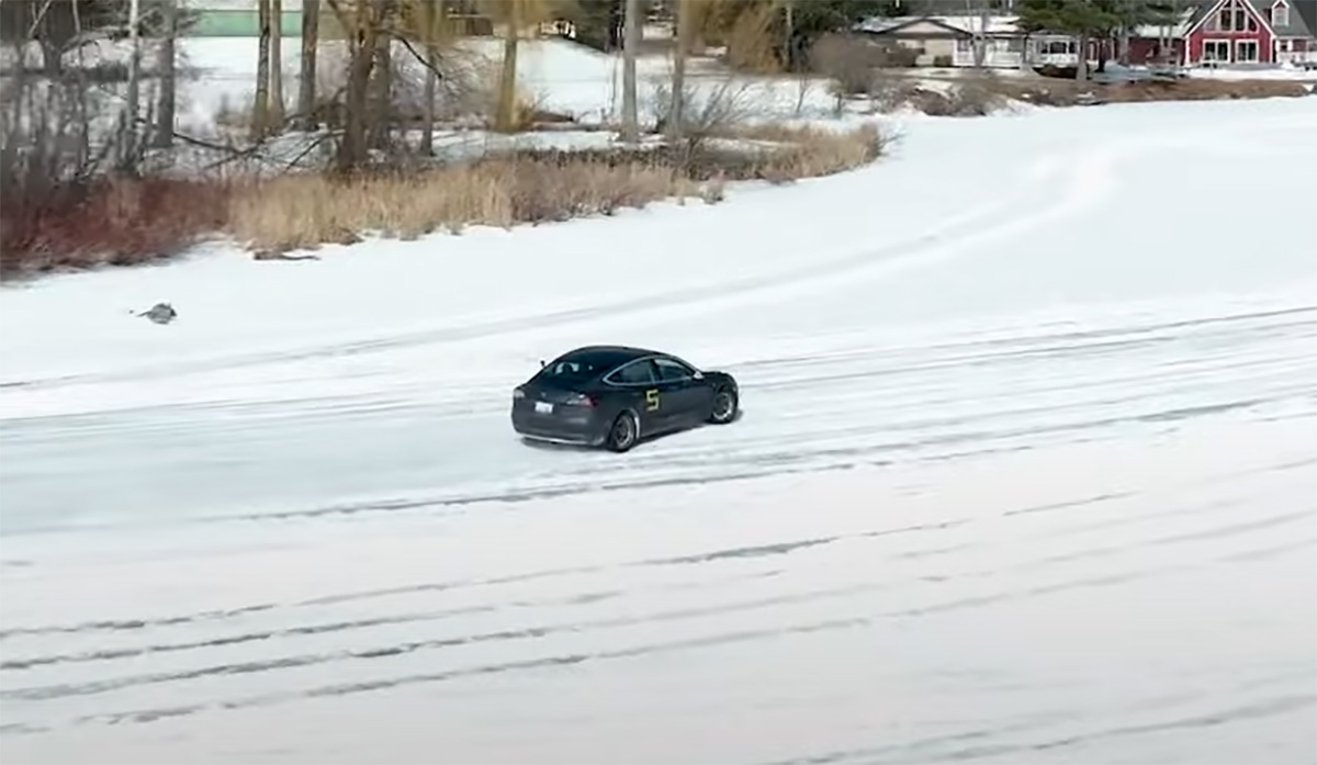 Car and Driver Tesla Model 3 drifting on a frozen lake during icy autocross event