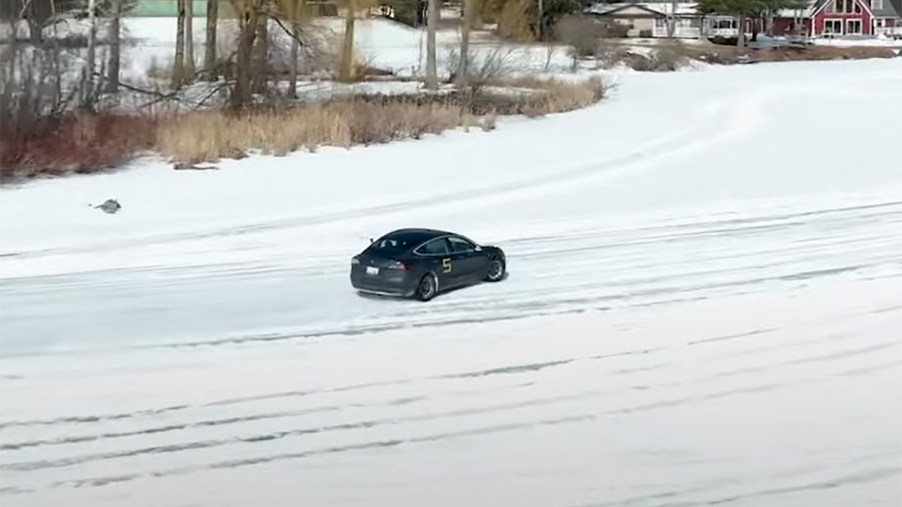 Car and Driver Tesla Model 3 drifting on a frozen lake during icy autocross event