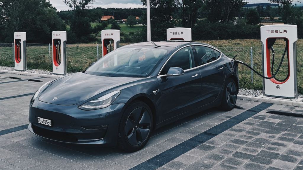 Tesla Model 3 charging at Supercharger, highlighting how to use the Tesla Supercharger network