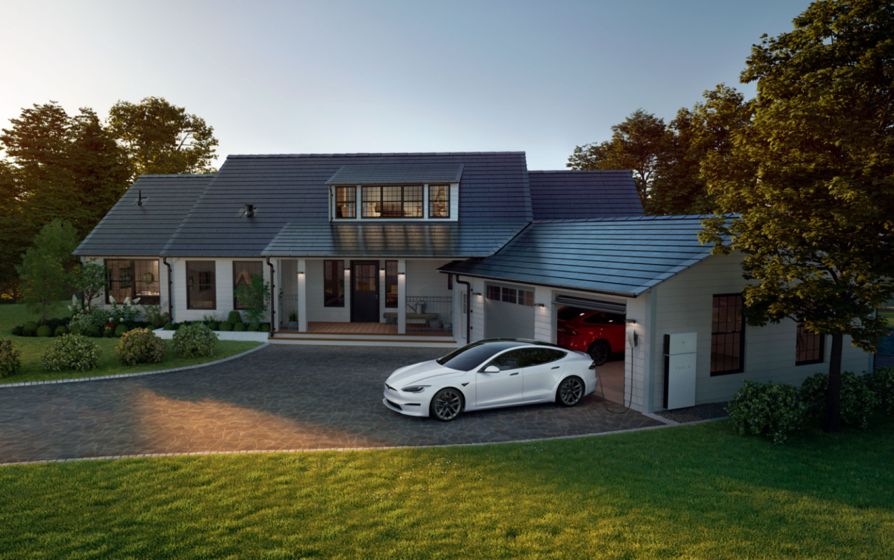 Tesla Model S plugged into a Tesla wall charger at home outside of a garage