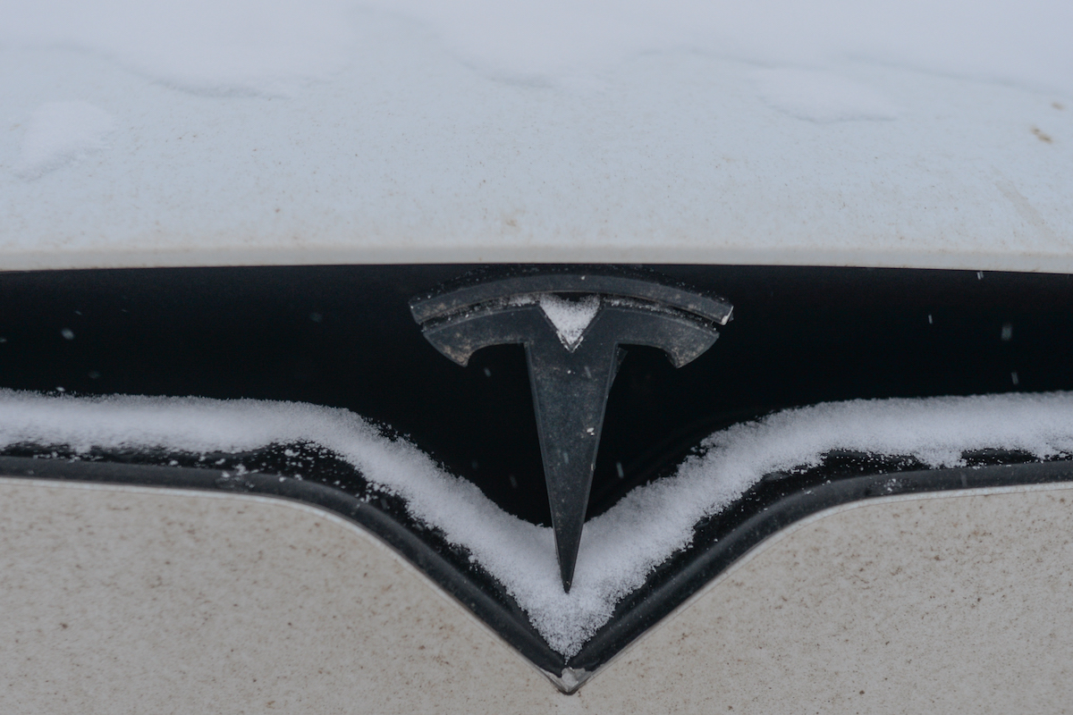 Tesla car covered with winter snow