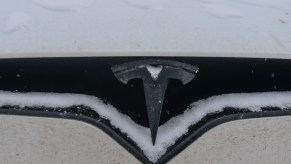 Tesla car covered with winter snow