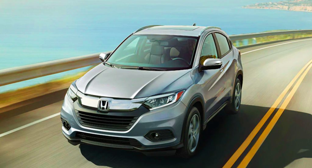 A silver 2022 Honda HR-V is driving on the road. 