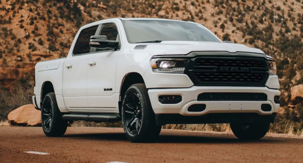 A white Ram 1500 is parked. 