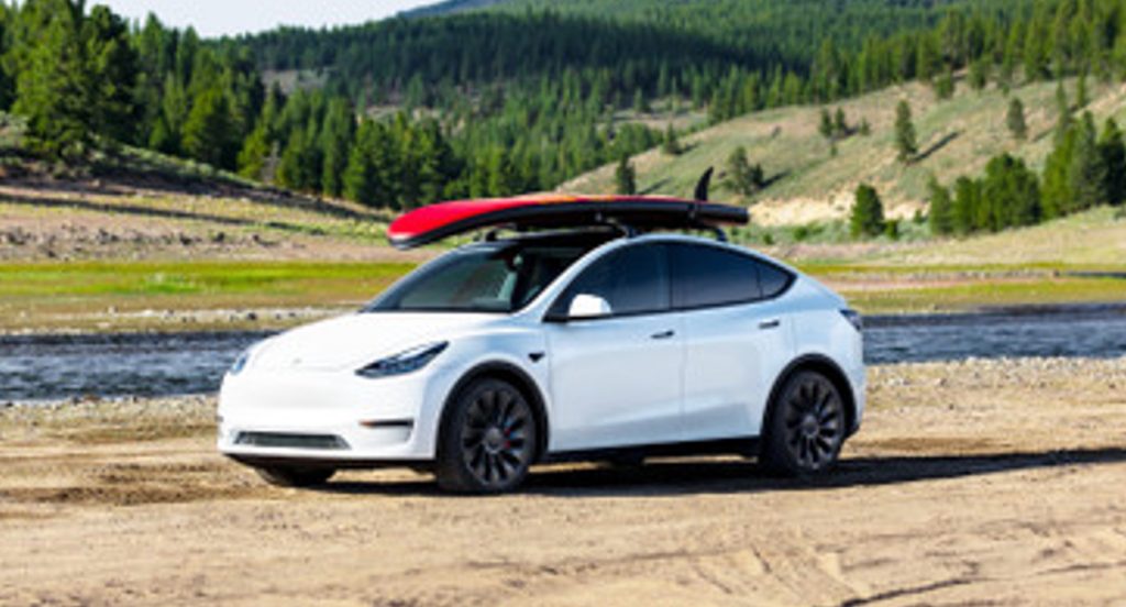 A white Tesla Model Y is parked. 