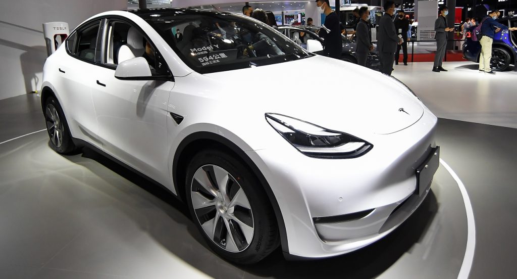 A white Tesla Model Y is on display. 