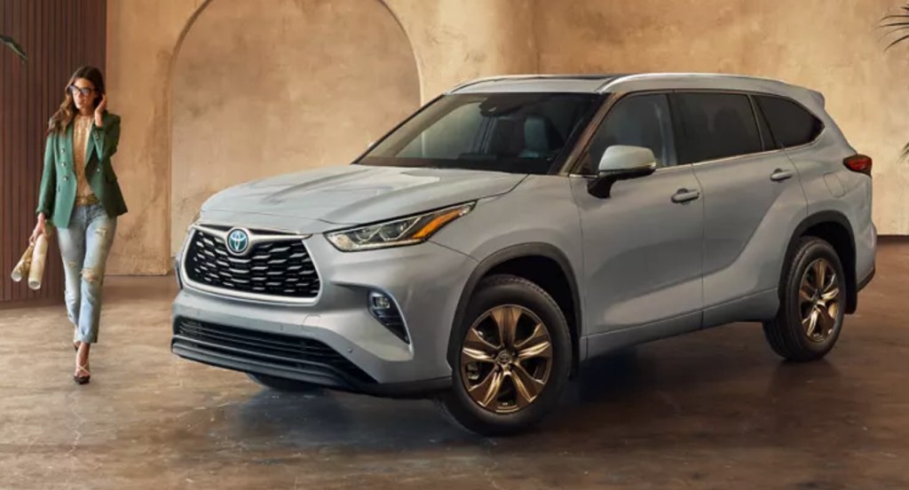 A gray 2022 Toyota Highlander Hybrid midsize SUV is parked indoors. 