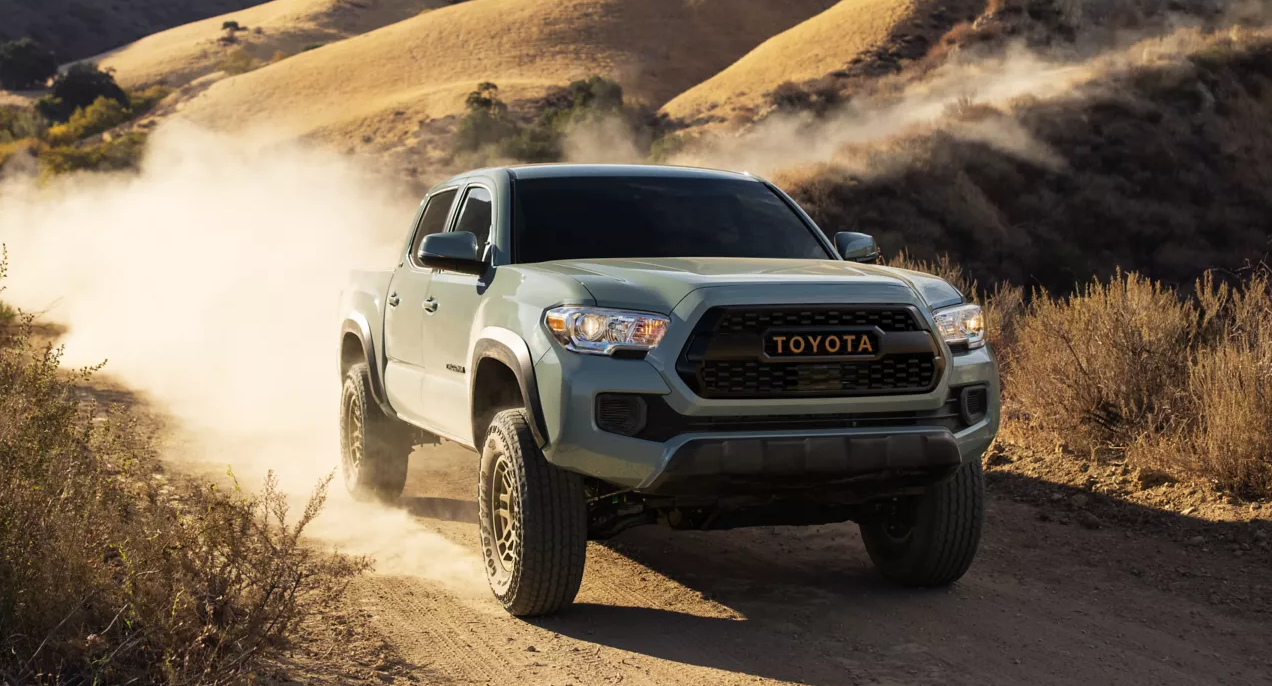 A green 2022 Toyota Tacoma is driving off-road.